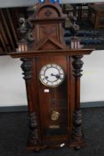 A Victorian stained beech wall clock with enamelled dial