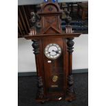 A Victorian stained beech wall clock with enamelled dial