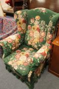 An early twentieth century green floral covered armchair