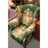 An early twentieth century green floral covered armchair