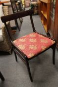 A contemporary mahogany effect dining table and four chairs