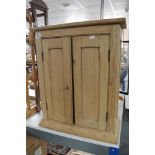 A pine double door cabinet CONDITION REPORT: This is a wall cabinet.