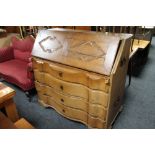 A nineteenth century oak serpentine fronted bureau