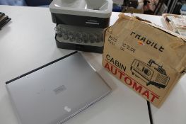 A Fujitsu laptop, coin sorter,