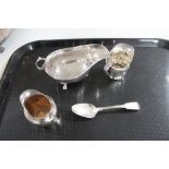A silver sauce boat together with two silver cream jugs and a silver spoon CONDITION