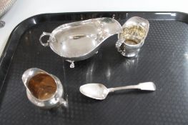 A silver sauce boat together with two silver cream jugs and a silver spoon CONDITION