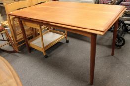 A teak extending table CONDITION REPORT: Some marks to top and scuffs to legs.