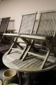 A wooden garden table and four chairs