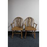 A pair of Windsor style carver armchairs