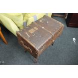 A vintage trunk on metal stand