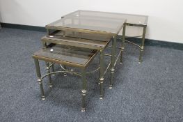 A nest of metal and glass topped tables together with a coffee table