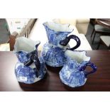 A set of three graduated blue and white Staffordshire style jugs