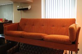 A mid century Danish three seater orange fabric settee CONDITION REPORT: In good