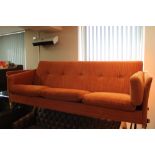 A mid century Danish three seater orange fabric settee CONDITION REPORT: In good