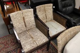 A pair of bergere armchairs in hide covering