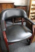 A reproduction mahogany studded black leather armchair