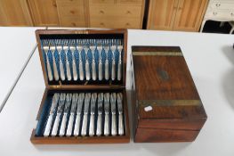 An antique mahogany box containing cutlery together with a wooden writing box