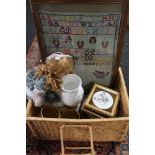A wicker basket containing a tapestry sampler, Aynsley vase, ceramic plaques, doll,