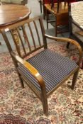 A mid century armchair with blue striped covering