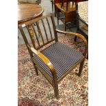 A mid century armchair with blue striped covering