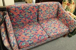 A mid century purple floral striped two seater settee