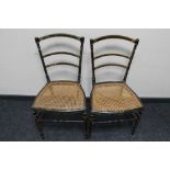 A pair of ebonised bergere seated bedroom chairs