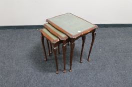 A nest of mahogany carved tables