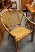 An early twentieth century wicker trolley together with a later armchair