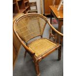 An early twentieth century wicker trolley together with a later armchair