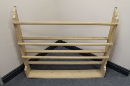 A stripped pine wall mounted plate rack