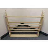 A stripped pine wall mounted plate rack