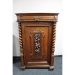 A nineteenth century carved oak wall cabinet