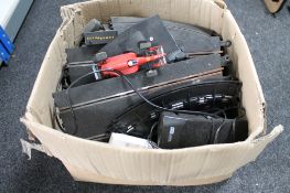 A box of slot racing track and cars