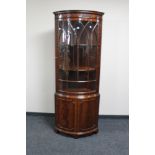 A reproduction mahogany glazed corner cabinet