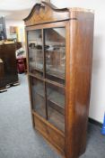 An antique glazed display cabinet