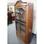 An antique glazed display cabinet