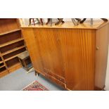 A mid century teak sideboard fitted with two drawers