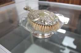 A silver footed glass dish and a plated hand mirror