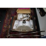 An unplumbed ceramic sink with brass fittings and taps