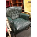 A green buttoned leather mid century armchair