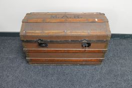 A vintage wooden bound domed trunk