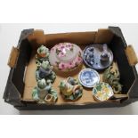 A box containing decorative china frog figures,
