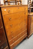 A mid century stained beech seven drawer chest