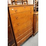 A mid century stained beech seven drawer chest