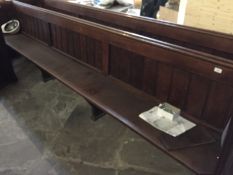 An oak pew. length 346 cm.