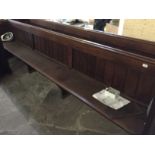 An oak pew. length 346 cm.