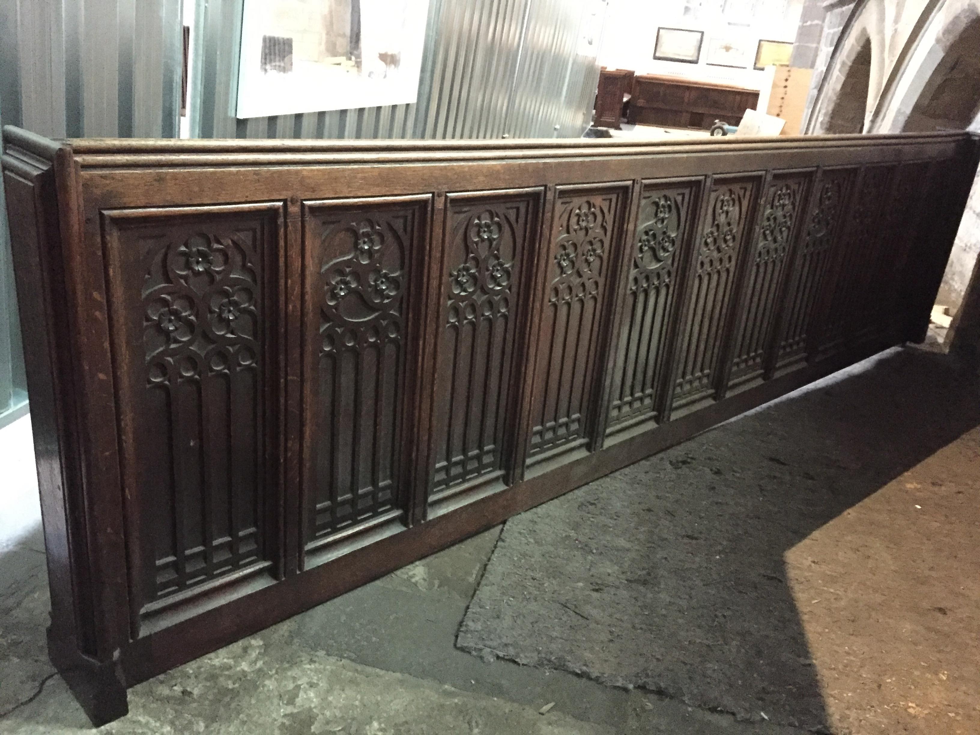 A carved oak front rail, length 336 cm, height 86 cm.