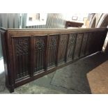 A carved oak front rail, length 336 cm, height 86 cm.