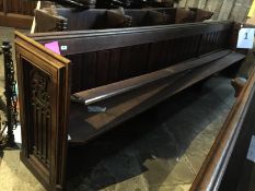 An oak pew. length 336 cm.