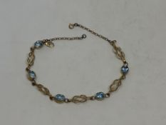 A gold and aquamarine bracelet